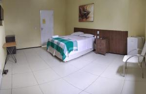 מיטה או מיטות בחדר ב-Pousada Itarema Residence