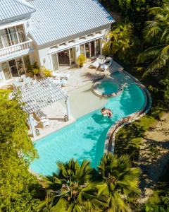 an aerial view of a swimming pool in front of a house at Eden Roc Cap Cana in Punta Cana