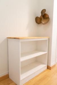 a white book shelf against a white wall at Sweet Home, Cuatro Caminos in A Coruña