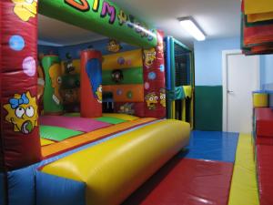 una sala de juegos para niños con un tobogán y una zona de juegos en Hostal Beti-jai, en Aoiz