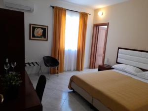 Posteľ alebo postele v izbe v ubytovaní Siracusa breakfast & rooms