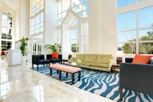 a living room with a couch and chairs at Grupotel Parc Natural & Spa in Playa de Muro