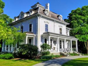 a large white house with a turret at Proctor Mansion Inn in Wrentham