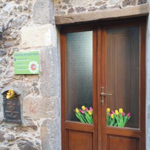 a wooden door with tulips in a window at Sardinia Retreat Base is your 14th Century home with expert tips in Santu Lussurgiu