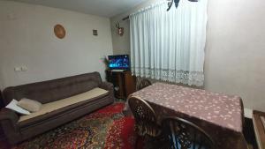 a living room with a couch and a table at Kuća za odmor Virtus Goč in Vrnjačka Banja