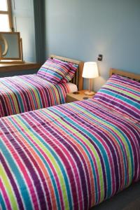 Кровать или кровати в номере Northlight Apartments - The Loom