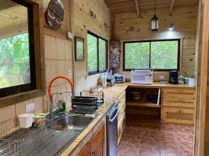 a kitchen with a sink and a counter top at Casa Mediterránea with Pool and 2100 m2 Garden near Beach and Rain Forest in Uvita