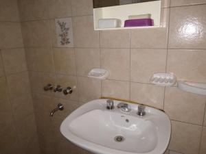 a bathroom with a white sink and a mirror at Cabañas Orión in Potrerillos +29 photos