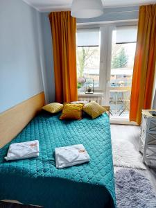 a bedroom with a bed with two pillows on it at Apartament Wągrowiec, Gabi - Remigiusz Kiszka in Wągrowiec