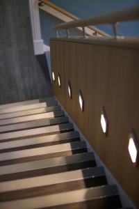 a staircase in a building with lights on it at Northlight Apartments - The Loom in Orkney