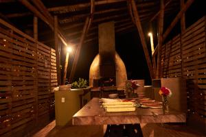 a room with a wooden table with a stove at Coffee & Adventure Hotel by La Palma y El Tucan in Zipacón