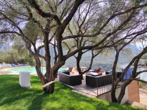a group of trees in a yard with a couch at Hotel Villa Cedrino in Dorgali