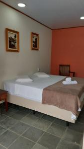 A bed or beds in a room at Pousada Casa Doce Vida