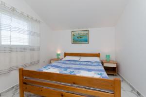 Postel nebo postele na pokoji v ubytování Apartments Slobodanka