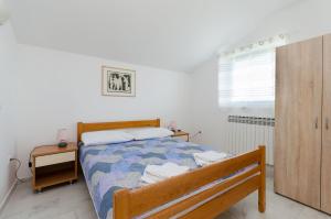 Postel nebo postele na pokoji v ubytování Apartments Slobodanka