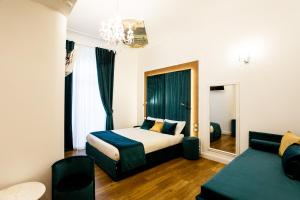 a hotel room with a bed and a couch at Atmosfere Guest House - Cinque Terre e La Spezia in La Spezia