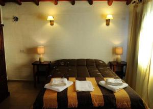 a bedroom with a bed with two towels on it at Cabanias El Aguaribay in San Javier +55 photos