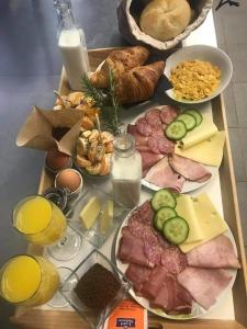 een dienblad met verschillende soorten voedsel op een tafel bij Apartments Bego Spa & Wellness in Crikvenica