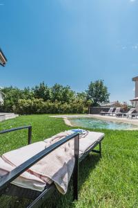 a bed sitting on the grass in a yard at Apartments Bego Spa & Wellness in Crikvenica