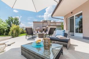 a patio with a couch and a table at Apartments Bego Spa & Wellness in Crikvenica
