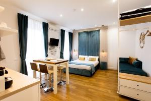 a bedroom with a bed and a desk in a room at Apartments and Suites 5 Terre La Spezia in La Spezia