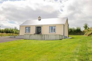 a house with a large yard in front of it at John & Margarets Place in Ballinamore