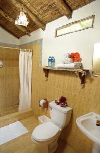 a bathroom with a toilet and a sink at Ocean View Happy Hill in Olón