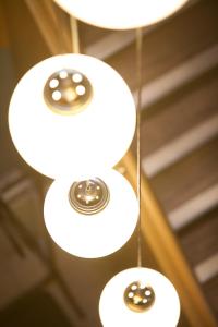 three white lights hanging from a ceiling at Northlight Apartments - The Lookout in Kirkwall