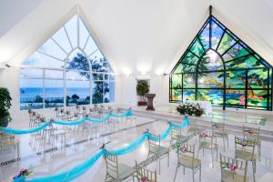 a room with tables and chairs and a stained glass window at The Auhana in Boracay