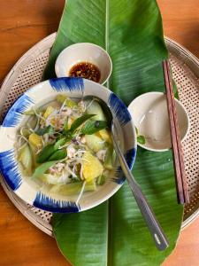 a bowl of soup on a plate on a banana leaf at Nông Trại Thảnh Thơi in Ben Tre +52 photos