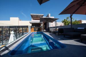 a swimming pool on the roof of a building at Hotel Madi in San Miguel de Allende