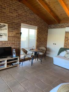 a living room filled with furniture and a tv at Nautilus Retreat Kalbarri B&B in Kalbarri