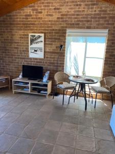 a living room with a couch and a table at Nautilus Retreat Kalbarri B&B in Kalbarri