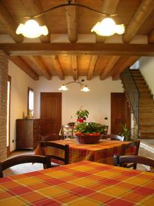 a dining room with a table and chairs and a staircase at Agriturismo Zennare in Chioggia
