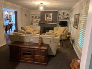 a living room with two couches and a fireplace at Studio Cottages "Bungalow" in Sydney