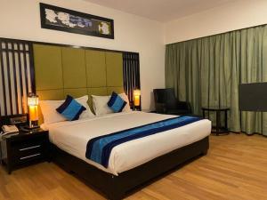 - une chambre avec un grand lit dans une chambre d'hôtel dans l'établissement Ebony Boutique Hotel, à Hyderabad
