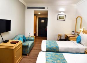 Postel nebo postele na pokoji v ubytování Golden Parkk Hotel