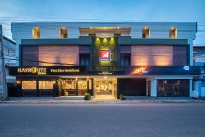 a large building with a store front with at Time Square Boutique Hotel & Spa in Alleppey