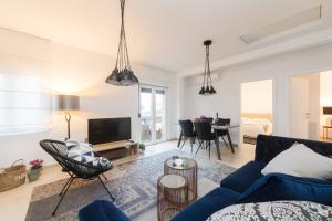 a living room with a blue couch and a tv at Apartment Ema in Zadar