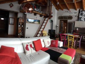 sala de estar con sofá blanco y almohadas coloridas en Baita di charme con vista meravigliosa en Verrayes