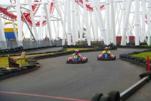 two people riding in toy cars down a race track at Great Deals at The Grange, Ingoldmells in Skegness