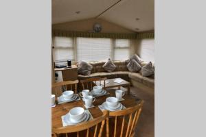 a living room with a couch and a table at Great Deals at The Grange, Ingoldmells in Skegness