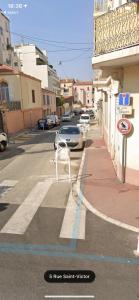 a white chair sitting on the side of a street at LE 31 in Cannes