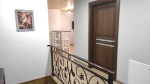a hallway with a wooden door and a staircase at Gospodarstwo agroturystyczne U Kierpców. in Podwilk