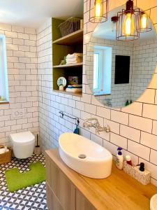 a bathroom with a sink and a mirror at Chyža retro apartmán in Prievidza