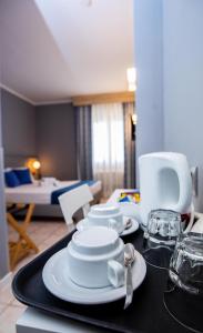a table with plates and glasses on a black tray at Bike&Boat Argentario Hotel in Porto Santo Stefano