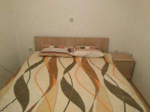 a bed with two pillows on top of it at Apartments Filemi in Ohrid