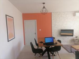 a room with a table with a laptop on it at Apartament Provence in Burgas