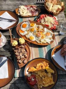 a table with plates of food on top at Etno village Katun in Žabljak