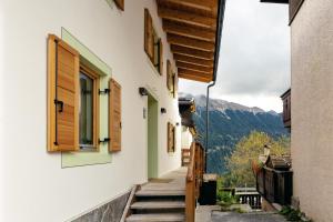 a stairway leading up to a building with wooden doors at La casa! in Vigo di Fassa